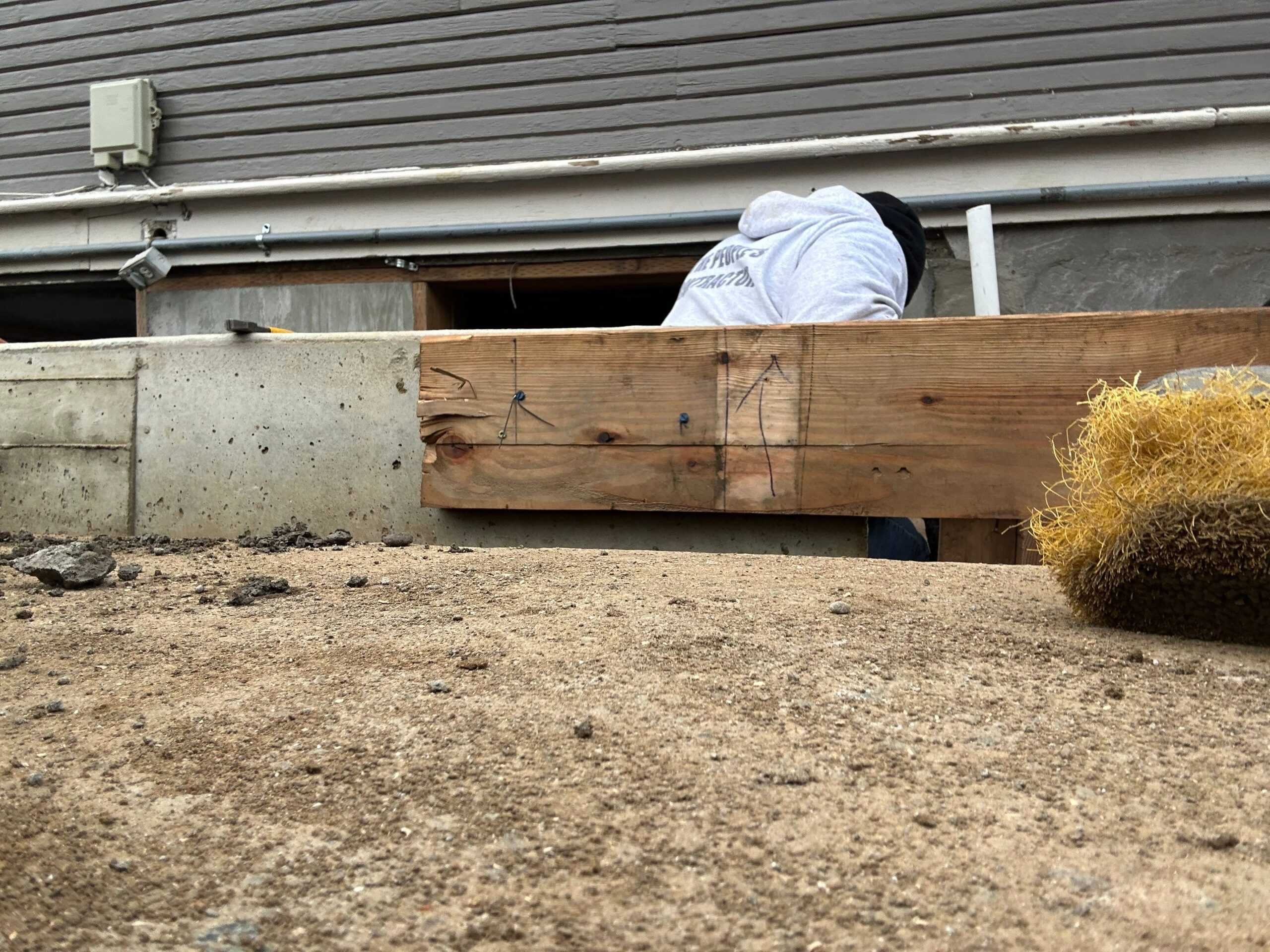 contractor plastering, repairing stucco house foundation after styrofoam insulation